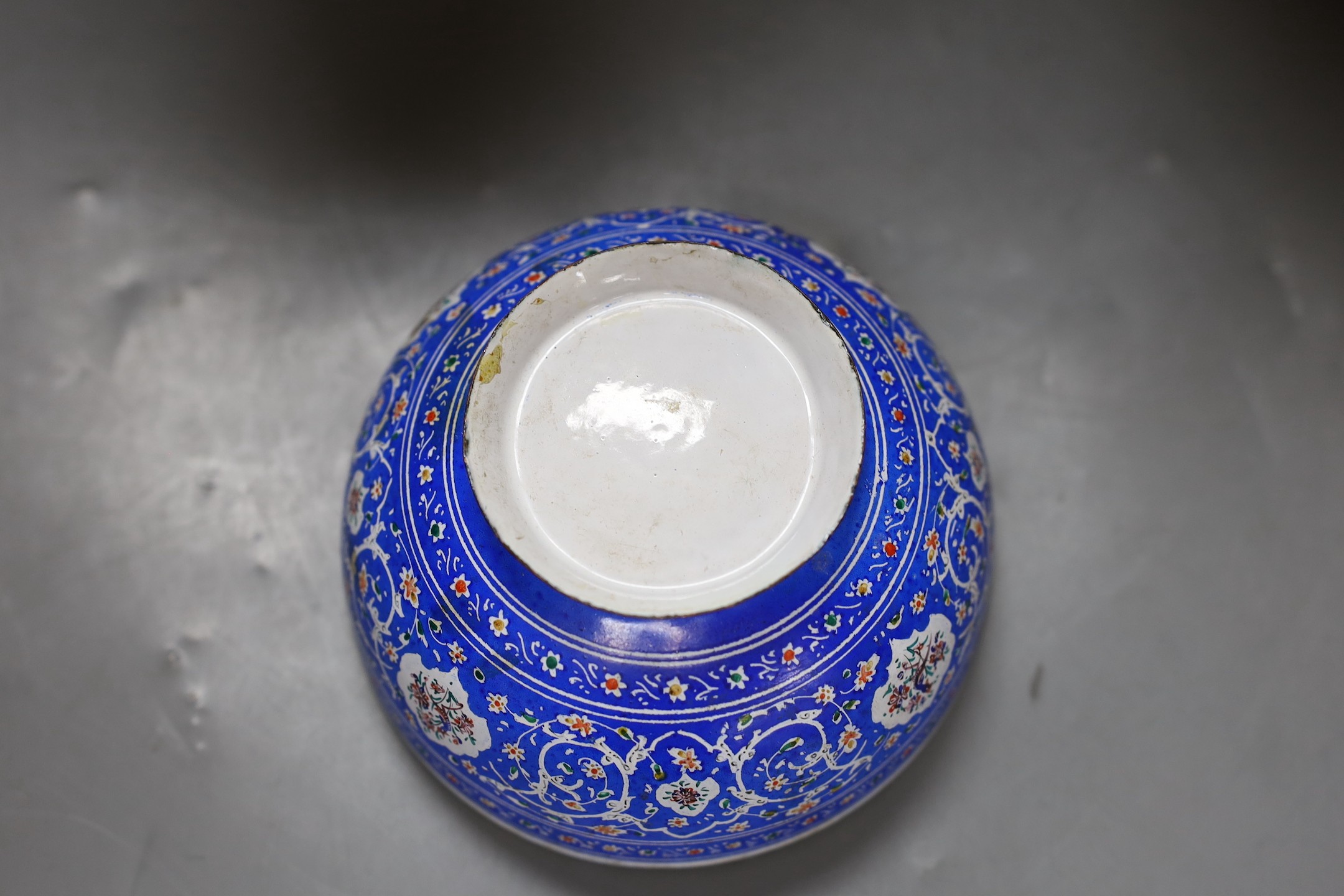 A pair of Indian carved wood vases, 22.5cm high, and a Persian blue enamel bowl (3)